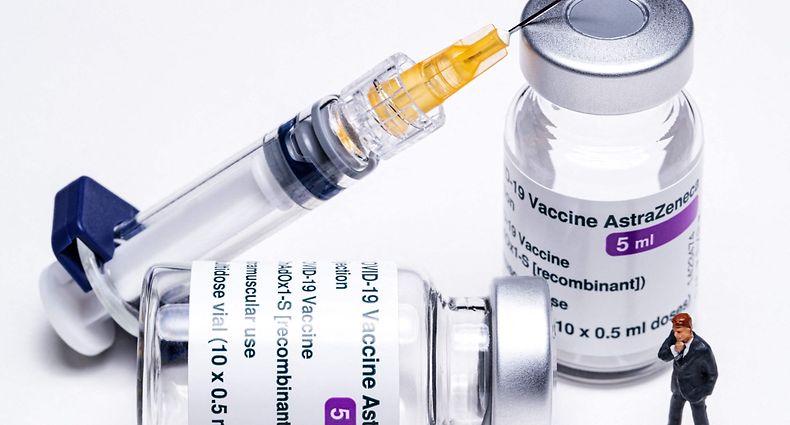 (FILES) In this file photo taken on March 11, 2021 This picture shows vials of the AstraZeneca Covid-19 vaccine, a syringe and a figurine in Paris. - The European Union is very unlikely to renew its Covid-19 vaccine contracts with pharmaceutical company AstraZeneca, a French minister said on April 16, 2021. (Photo by JOEL SAGET / AFP)