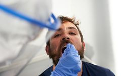 08.08.2020, Hessen, Frankfurt/Main: Dem US-Amerikaner Edward Hurne wird am Frankfurter Flughafen ein Rachenabstrich für den Coronavirus-Test abgenommen. Seit heute besteht die Testpflicht für Rückkehrer aus Risikogebieten. Foto: Thomas Frey/dpa +++ dpa-Bildfunk +++