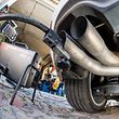 A measuring hose for emissions inspections in diesel engines sticks in the exhaust tube of a Volkswagen (VW) Golf 2,0 TDI diesel car at a garage in Frankfurt an der Oder, eastern Germany, on October 1, 2015. Volkswagen has admitted that up to 11 million diesel cars worldwide are fitted with devices that can switch on pollution controls when they detect the car is undergoing testing.       AFP PHOTO / DPA / PATRICK PLEUL   +++   GERMANY OUT   +++