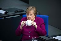 German Chancellor Angela Merkel holds a protective face mask during a session at the Bundestag (Germany's lower house of parliament) in Berlin on March 25, 2021, ahead of a EU summit. (Photo by STEFANIE LOOS / AFP)