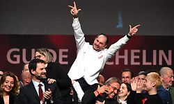 TOPSHOT - Alexandre Couillon celebrates after being awarded a third Michelin star, during the 2023 edition of the Michelin guide awards ceremony on March 6, 2023 in Strasbourg, eastern France. (Photo by PATRICK HERTZOG / AFP)