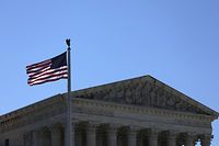 WASHINGTON, DC - JUNE 29: A U.S. flag flies near the U.S. Supreme Court building June 29, 2022 in Washington, DC. The Court is expected to hand down a ruling tomorrow on whether the Biden administration can end the Trump-era Migrant Protection Protocols (MPP) program, which has kept asylum-seekers in Mexico since 2019.   Alex Wong/Getty Images/AFP
== FOR NEWSPAPERS, INTERNET, TELCOS & TELEVISION USE ONLY ==