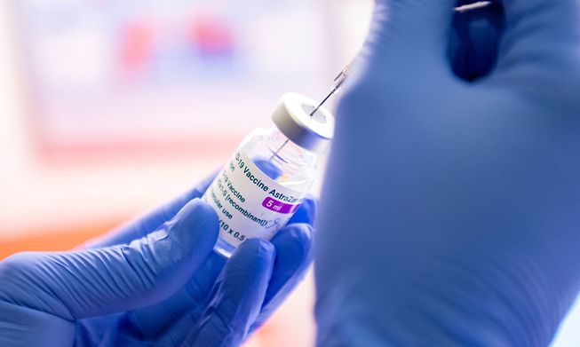 A nurse fills a syringe with the AstraZeneca vaccine at a doctor's office in southern Germany