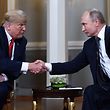 TOPSHOT - Russian President Vladimir Putin (R) and US President Donald Trump shake hands before a meeting in Helsinki, on July 16, 2018. / AFP PHOTO / Brendan Smialowski