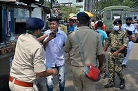 Police detain people who flouted the Covid-19 coronavirus safety protocols of wearing face mask during an awareness drive held in Siliguri on April 25, 2021. (Photo by DIPTENDU DUTTA / AFP)