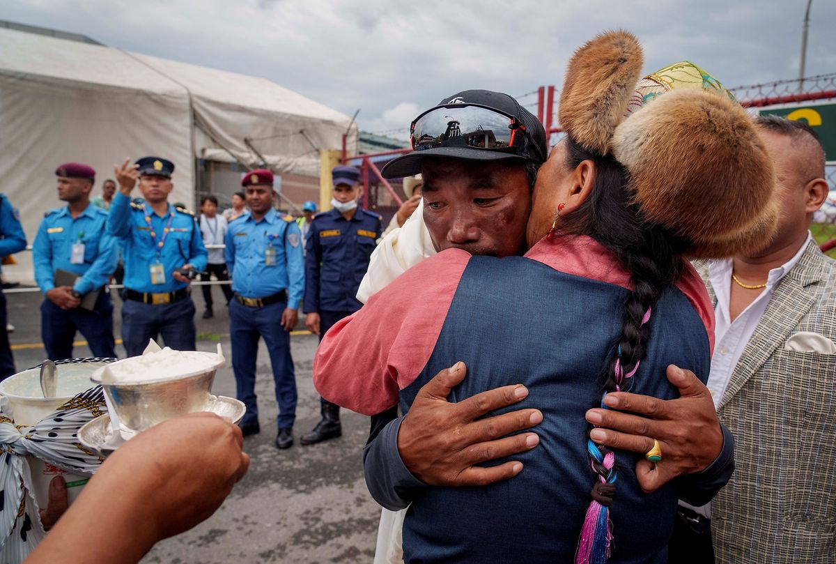 Kami Rita umarmt seine Frau, nachdem er von der 28. Besteigung des Mount Everest den Flughafen in Kathmandu erreicht. 