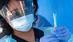 A health worker prepares a vaccine during the Saban Community Clinic Vaccine Drive Up for LA Children first day event, August 12, 2020, in Los Angeles, California. - Vaccines are still required to enroll for school. Every family, including those without health insurance insurance, can get their school-vaccinations at the Saban Community Clinic drive up. (Photo by VALERIE MACON / AFP)