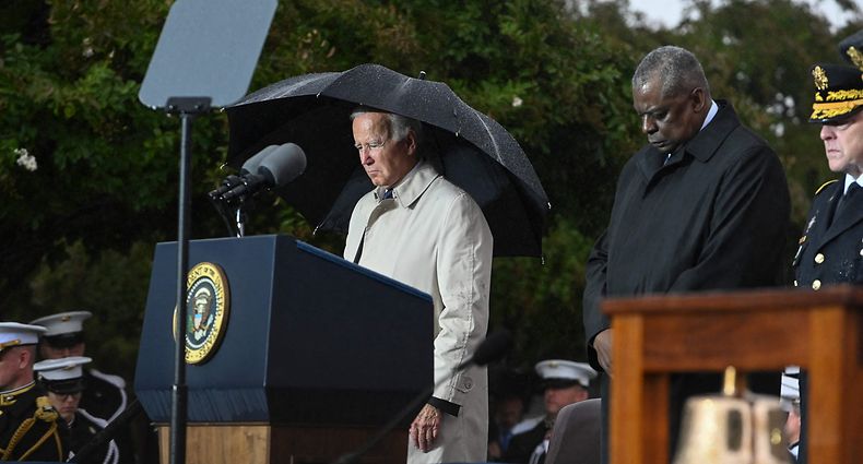 (L-R) US President Joe Biden, US Defense Secretary Lloyd Austin, and Chairman of the Joint Chiefs of Staff General Mark Milley bow their heads for a moment of silence during a remembrance ceremony to mark the 21st anniversary of the 9/11 attacks, at the Pentagon in Washington, DC, on September 11, 2022. (Photo by ROBERTO SCHMIDT / AFP)
