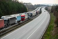 A picture taken on March 19, 2020 shows trucks stuck in a traffic jam on the A4 highway, some 40km far from Germany's border to Poland near Bautzen, eastern Germany. (Photo by JENS SCHLUETER / AFP)