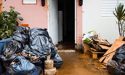 This photograph taken on September 18, 2022, shows the mudded entrance of a home and damaged goods after the passage of Hurricane Fiona in Goyave, on the French island of Guadeloupe. (Photo by Carla Bernhardt / AFP)