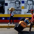 TOPSHOT - Venezuelans cross the Simon Bolivar bridge from Colombia to San Antonio del Tachira, in Venezuela on February 22, 2019. (Photo by Federico Parra / AFP)