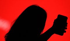 A guest takes a selfie with her smartphone during the Mercedes Benz Fashion Week in Madrid on April 8, 2021. (Photo by Gabriel BOUYS / AFP)