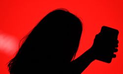 A guest takes a selfie with her smartphone during the Mercedes Benz Fashion Week in Madrid on April 8, 2021. (Photo by Gabriel BOUYS / AFP)