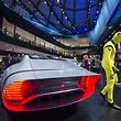 A man dressed as a crash test dummy walks past a Mercedes Benz concept car IAA displayed during the second press day of the 66th IAA auto show in Frankfurt am Main, western Germany, on September 16, 2015. 
AFP PHOTO / ODD ANDERSEN