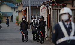 TOPSHOT - Police officers are seen near the scene of a standoff where a suspect, believed to be a farmer in his 30s, was holed up inside a building in the Ebe area of Nakano, Nagano Prefecture, early morning on May 26, 2023. Japanese police on May 26 detained a suspect who had been holed up in a building after allegedly killing four people including two police officers in a gun and knife attack, an official told AFP. (Photo by JIJI Press / AFP) / Japan OUT