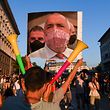 A protestor holds a collage mocking the Bulgarian Prime minister wearing a protective mask  made of a 500 euros bill during an anti-government protest in Sofia, on July 29, 2020, as thousands of people have been demanding for weeks, for the resignation of the government which they accuse of protecting the oligarchy. (Photo by NIKOLAY DOYCHINOV / AFP)