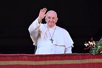 Pope Francis waves to the crowd as he appears at the balcony to deliver his Christmas Urbi et Orbi blessing in St. Peter's Square at The Vatican on December 25, 2022. (Photo by Andreas SOLARO / AFP)