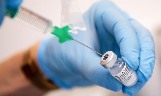 A vaccine syringe and vial
