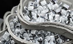 A picture taken on April 8, 2021 shows empty vials of the Pfizer/BioNTech vaccine against the Covid-19 at the 104 Art Center in Paris, as part of France's vaccination campaign aimed at curbing the spread of the Covid-19 pandemic. (Photo by ALAIN JOCARD / AFP)