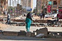 TOPSHOT - Sudanese anti-coup protesters use bricks to barricade a street in the capital khartoum on October 27, 2021, amid ongoing demonstrations against a military takeover that has sparked widespread international condemnation. (Photo by AFP)
