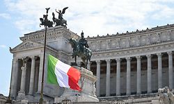 The Italian flag flies at half-mast on the Altare della Patria - Vittorio Emanuele II monument in Rome on March 31, 2020 as flags are being flown at half-mast in cities across Italy to commemorate the victims of the virus, during the country's lockdown aimed at curbing the spread of the COVID-19 infection, caused by the novel coronavirus. (Photo by ANDREAS SOLARO / AFP)