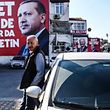 A man stands in front of an "Event" (Yes) campaign billboard bearing the portrait of Turkish President Recep Tayyip Erdogan on March 30, 2017, in Istanbul, two weeks ahead of a referendum on whether to change the current parliamentary system into an executive presidency.
Campaigning by both the "Evet"(Yes) and "Hayir" (No) camps has intensified this week ahead of Turkey holding a constitutional referendum on April 16, 2017. Turks will vote on 18 proposed amendments to the Constitution of Turkey. The controversial changes seek to replace the parliamentary system and move to a presidential system which would give President Recep Tayyip Erdogan executive authority. / AFP PHOTO / BULENT KILIC