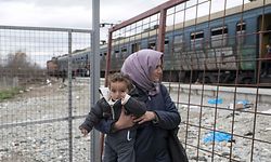 A migrant woman carries a child as she waits to board a train after crossing the Greek-Macedonian border, near Gevgelija, on February 14, 2016.
Dutch Foreign minister Bert Koenders on February 14 spent an hour in a Vinojug recipient center near Gevgelija talking with migrants, children, UNICEF and Red Cross representatives, police and others members that are taking care of migrants that are heading to the EU from devastated homes in Syria, Afghanistan and Iraq. / AFP / Robert ATANASOVSKI