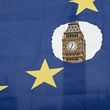 TOPSHOT - A pro-remain protester holds up an EU flag with one of the stars symbolically cut out in front of the Houses of Parliament shortly after British Prime Minister Theresa May announced to the House of Commons that Article 50 had been triggered in London on March 29, 2017. 
Prime Minister Theresa May today said there could be "no turning back" and called for national unity, after notifying the EU of Britain's intention to end its 44-year membership of the bloc. / AFP PHOTO / OLI SCARFF