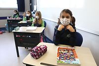Pupils wearing protective facemasks sit in a classroom of a school in Ankara on March 2, 2021, after the country lifted restrictions measures against the Covid-19 pandemic in regions with lower infection rates. - Turkey on March 1, re-opened most restaurants for indoor dining and allowed more students to return to school as it rolled back tough coronavirus restrictions. (Photo by Adem ALTAN / AFP)