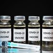 An illustration picture shows vials with Covid-19 Vaccine stickers attached, and syringes, on November 17, 2020. (Photo by JUSTIN TALLIS / AFP)