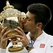 Novak Djokovic of Serbia kisses the trophy after winning his Men's Singles Final match against Roger Federer of Switzerland at the Wimbledon Tennis Championships in London, July 12, 2015.                                                        REUTERS/Stefan Wermuth      TPX IMAGES OF THE DAY     