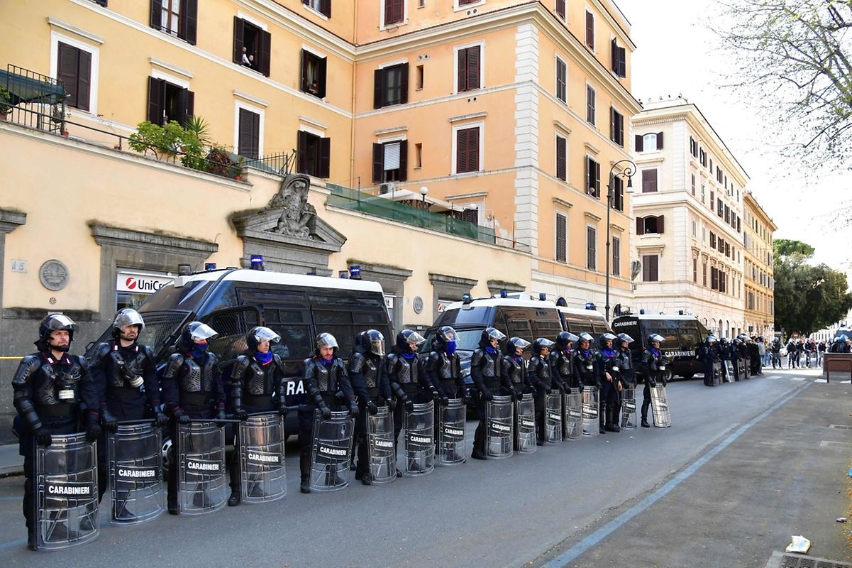 Die römische Bereitschaftspolizei beschützt eine Bank an der Route der Gegendemo "EuroStop"