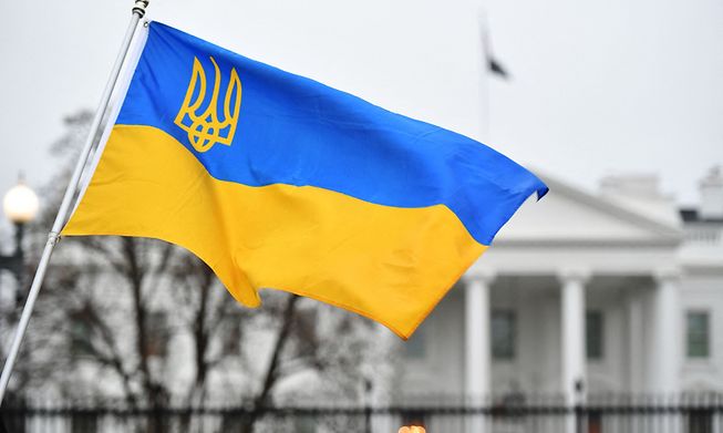 The flag of Ukraine with its coat of arms flutters as activists gather in Lafayette Square to protest Russia's invasion of Ukraine in Washington, DC, on February 24, 2022