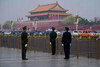 A police (R) and two paramilitary police officers take position near Tiananmen Square in Beijing on March 27, 2018. 
Speculation intensified on March 27, 2018 that North Korean leader Kim Jong-Un was in Beijing for a surprise visit, after Japanese media reported the arrival of a special North Korean train met by an honour guard under tight security. / AFP PHOTO / WANG ZHAO