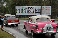 Old American cars drive near a government's campaign billboard encouraging to vote for the Constitution in Havana, on February 13, 2019. - On buses, in supermarkets or in television: in Cuba, the slogan of the socialist government #YoVotoSi (I vote yes) to the new Constitution, that will be submitted to a referendum on February 24, is omnipresent, sparking discontent in social networks. (Photo by YAMIL LAGE / AFP)