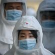 TOPSHOT - In this photo taken on March 12, 2020, medical workers wearing protective clothing against the COVID-19 novel coronavirus walk to a decontamination area at the Keimyung University hospital in Daegu. - South Korea -- once the largest coronavirus outbreak outside China -- saw its newly recovered patients exceed fresh infections for the first time on March 13, as it reported its lowest number of new cases for three weeks. (Photo by Ed JONES / AFP)