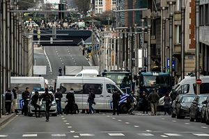 Police officers block the access to Maalbeek metro station in Brussels on March 22, 2016 after a series of apparently coordinated explosions ripped through Brussels airport and a metro train, killing at least 14 people in the airport and 20 people in the metro in the latest attacks to target Europe. Security was tightened across the jittery continent and transport links paralysed after the bombings that Belgian Prime Minister Charles Michel branded "blind, violent and cowardly". / AFP PHOTO / PHILIPPE HUGUEN