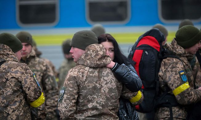 A Ukrainian serviceman says goodbye to his girlfriend before departing in the direction of Kyiv
