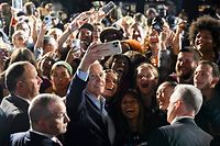 TOPSHOT - US President Joe Biden (C) poses for a selfie with supporters during a rally for Democratic candidates, including New York Governor Kathy Hochul, at Sarah Lawrence College in Bronxville, New York, on November 6, 2022. (Photo by SAUL LOEB / AFP)