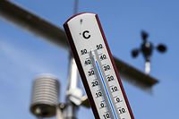 This picture taken on July 25, 2019 shows a thermometer indicating a temperature of over 40 degrees at a Royal Netherlands Meteorological Institute (KNMI) weather station at the Deelen Air Base in Arnhem, the Netherlands. - The Netherlands hit a new high temperature record of 41.7 degrees on July 25, meteorologists said, as a heatwave turned large parts of Europe into a furnace. The new record was set in the eastern Dutch town of Deelen, the Meteorological Institute said. The record temperature measured here has been later declared invalid. (Photo by Vincent Jannink / ANP / AFP) / Netherlands OUT
