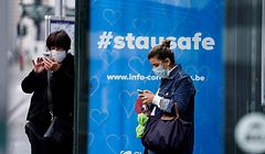A commuter wearing a protective face mask waits for a bus at the Gare Bruxelles-Central train station on May 4, 2020 in Brussels, amid the spread of the COVID-19 pandemic caused by the novel coronavirus. (Photo by Kenzo TRIBOUILLARD / AFP)