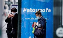 A commuter wearing a protective face mask waits for a bus at the Gare Bruxelles-Central train station on May 4, 2020 in Brussels, amid the spread of the COVID-19 pandemic caused by the novel coronavirus. (Photo by Kenzo TRIBOUILLARD / AFP)