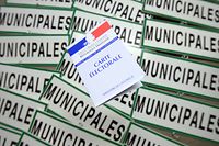 (FILES) In this file photo taken on March 18, 2014, a French voting card is displayed on "Mayoral" signs in a warehouse owned by the town hall of Rennes, western France. (Photo by DAMIEN MEYER / AFP)