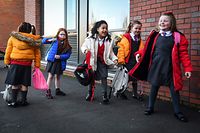 Pupils arrive at Clyde Primary School in Glasgow on February 22, 2021 as schools in Scotland started to reopen to more of the youngest students in an easing of the coronavirus shutdown. (Photo by Andy Buchanan / AFP)