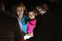 MCALLEN, TX - JUNE 12: Central American asylum seekers, including a Honduran girl, 2, and her mother, are taken into custody near the U.S.-Mexico border on June 12, 2018 in McAllen, Texas. The group of women and children had rafted across the Rio Grande from Mexico and were detained by U.S. Border Patrol agents before being sent to a processing center for possible separation. Customs and Border Protection (CBP) is executing the Trump administration's zero tolerance policy towards undocumented immigrants. U.S. Attorney General Jeff Sessions also said that domestic and gang violence in immigrants' country of origin would no longer qualify them for political asylum status.   John Moore/Getty Images/AFP
== FOR NEWSPAPERS, INTERNET, TELCOS & TELEVISION USE ONLY ==