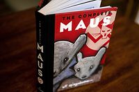 This photo taken in Los Angeles, California on January 27, 2022 shows the cover of the graphic novel "Maus" by Art Spiegelman. - A school board in Tennessee has added to a surge in book bans by conservatives with an order to remove the award-winning 1986 graphic novel on the Holocaust, "Maus," from local student libraries. Author Art Spiegelman told CNN on January 27 -- coincidentally International Holocaust Remembrance Day -- that the ban of his book for crude language was "myopic" and represents a "bigger and stupider" problem than any with his specific work. (Photo by Maro SIRANOSIAN / AFP) / RESTRICTED TO EDITORIAL USE - MANDATORY MENTION OF THE ARTIST UPON PUBLICATION - TO ILLUSTRATE THE EVENT AS SPECIFIED IN THE CAPTION