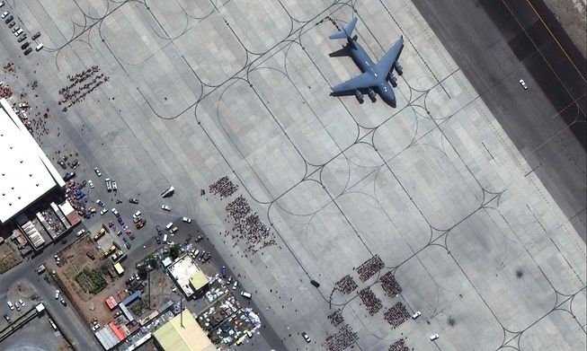 Crowds of people waiting on the tarmac at Kabul airport in Afghanistan