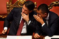 TOPSHOT - Italian Prime Minister Giuseppe Conte (L) speaks with Deputy Prime Minister and Minister of Economic Development, Labour and Social Policies, Luigi Di Maio (R) after delivering a speech at the Italian Senate, in Rome, on August 20, 2019, as the country faces a political crisis. - Italy's Premier Conte says to offer resignation during his speech at the Senate after calling Italy's far-right Interior Minister Matteo Salvini "irresponsible" to spark a political crisis by pulling the plug on the governing coalition. (Photo by Andreas SOLARO / AFP)