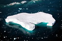 TOPSHOT - An aerial photo taken on August 15, 2019 shows an iceberg as it floats along the eastern cost of Greenland near Kulusuk (aslo spelled Qulusuk). (Photo by Jonathan NACKSTRAND / AFP)