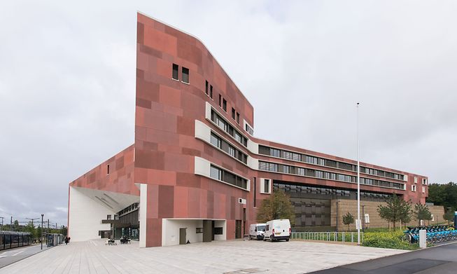 The red exposed concrete panels were treated with sand blasting, water and even acid washing to create the patchwork effect 